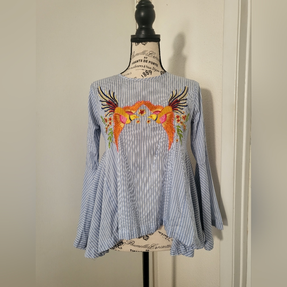 Blue and white striped top with stitched detail on front.